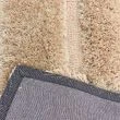 Denna produkten heter Moody Bow, tillverkad av Polyester material med en vacker Beige färg - SE Mattor